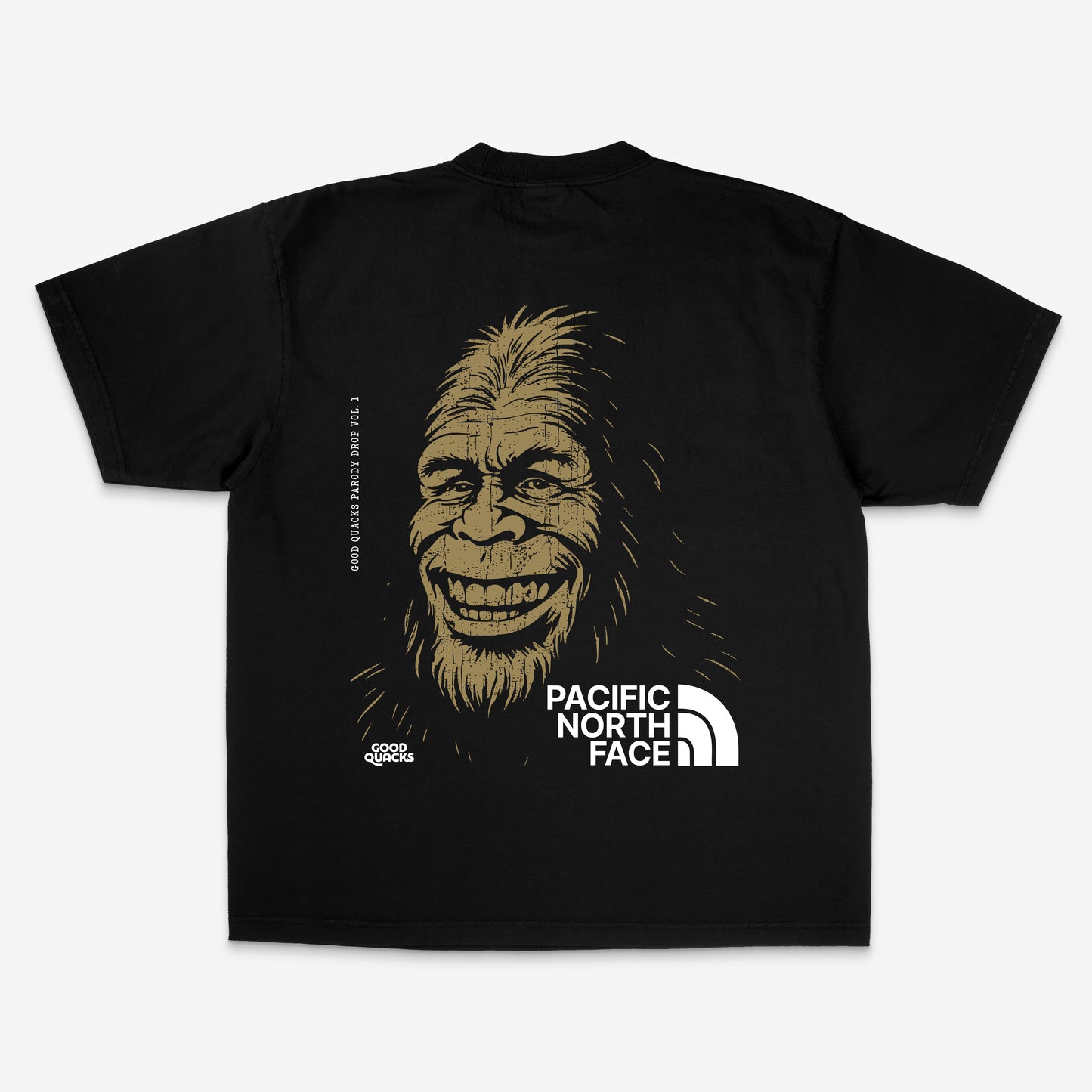 Illustration of a smiling Bigfoot with “Pacific North Face” parody logo, printed on a black shirt. Bold graphic with cryptid vibes, part of Good Quacks Parody Drop Vol. 1.

