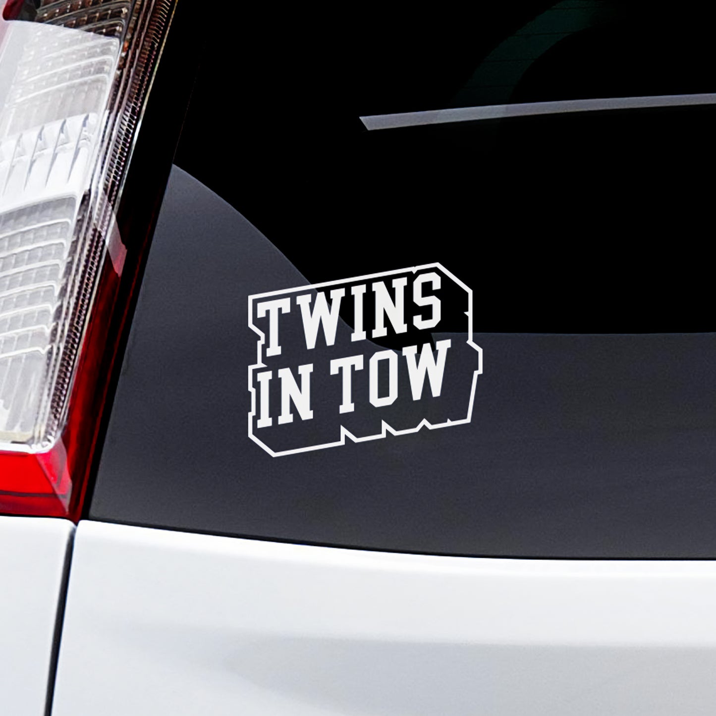 Twins in Tow sticker applied to a car window for twin family representation.